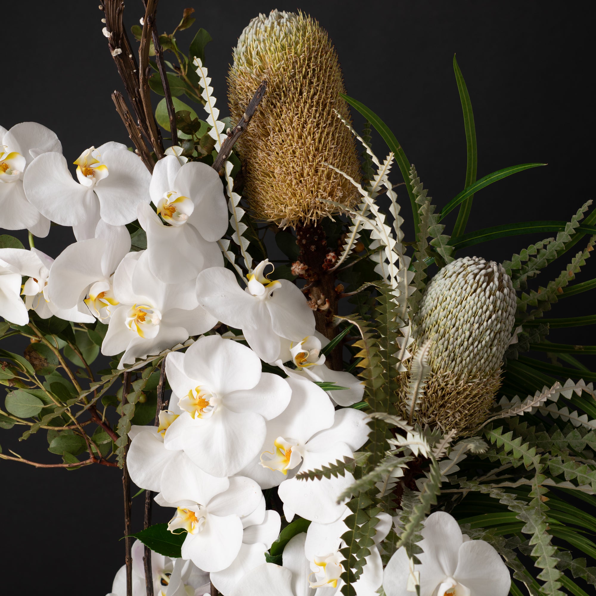 A luxurious sculptural floral display with cascading orchids and modern botanical elements, highlighting Bloom by Anuschka’s mastery in high-end floral design.