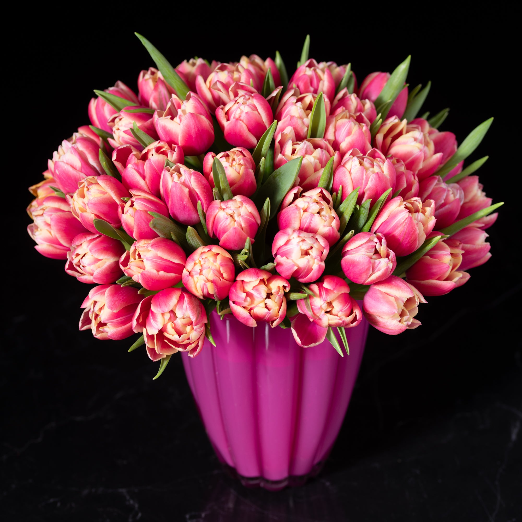 Elegant pink tulip bouquet with fresh green stems, designed by Bloom by Anuschka, showcasing expert flower crafting in Denver.