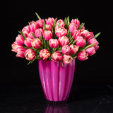 A lush arrangement of premium pink tulips in a striking pink vase, handcrafted by Bloom by Anuschka, a premier florist shop in Denver.