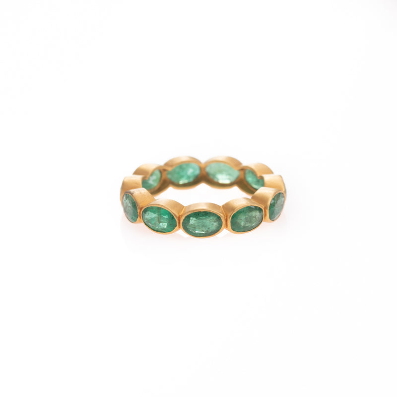 wide emeralds all around gold ring 