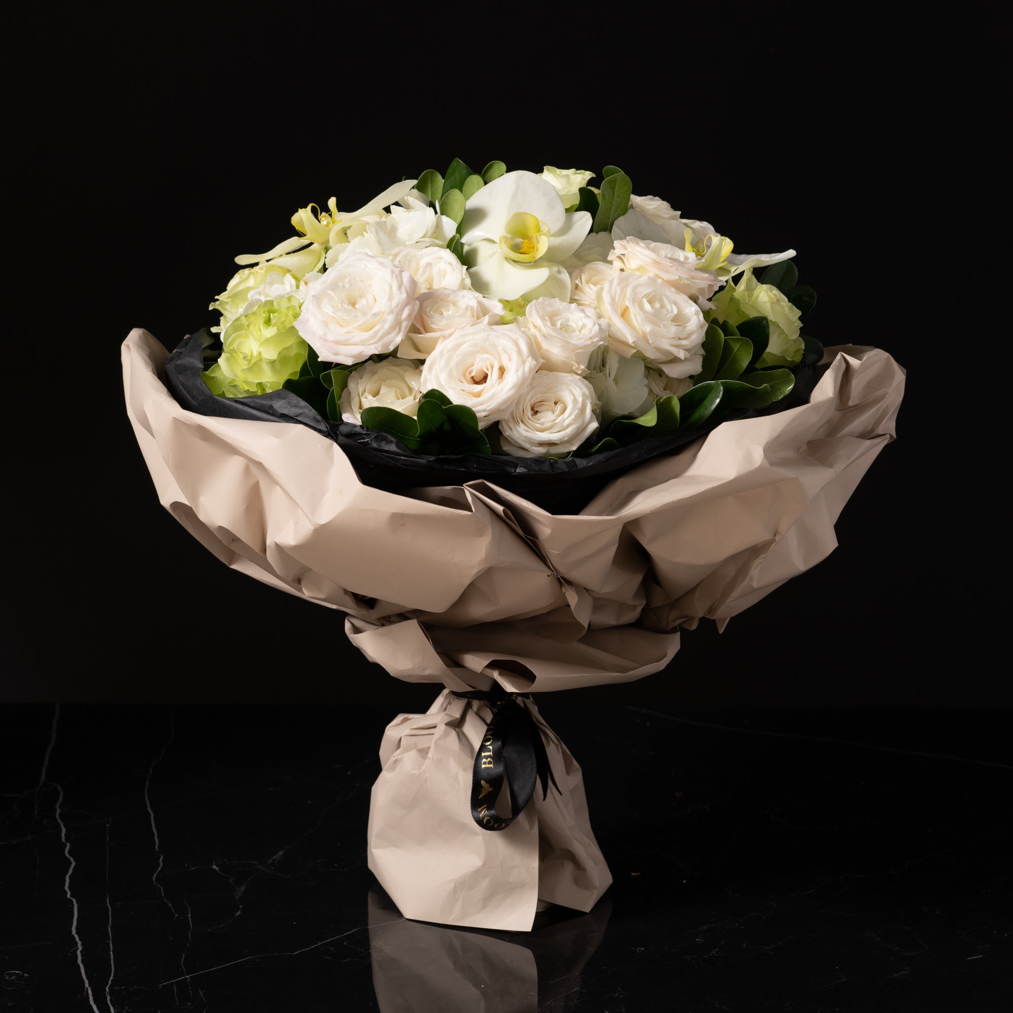 Bliss is a sophisticated wrapped bouquet featuring elegant white orchids, creamy roses, and soft hydrangeas, beautifully hand-tied and wrapped in luxe paper. Perfect for anniversaries, weddings, sympathy gifts, and refined celebrations, this timeless design is available for flower delivery in Denver, including Cherry Creek, Country Club, Hilltop, and Belcaro. Please note: Fresh flower delivery is limited to the local Denver area.