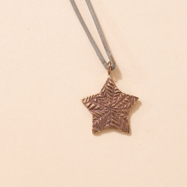 Small Bronze Star on Gray Leather Cord Necklace