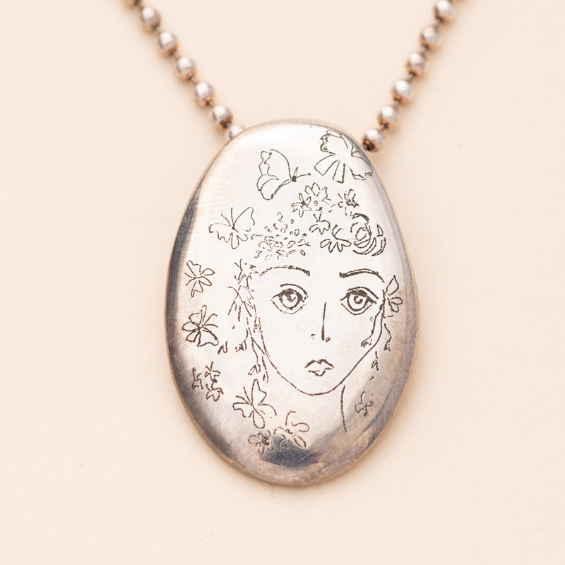 Face Pendant on a Sterling Silver 1 1/2" Sommer’s Oval with a Bead Chain.